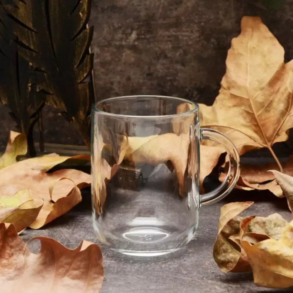 Paşabahçe Iconic clear glass mug beside decorative leaves
