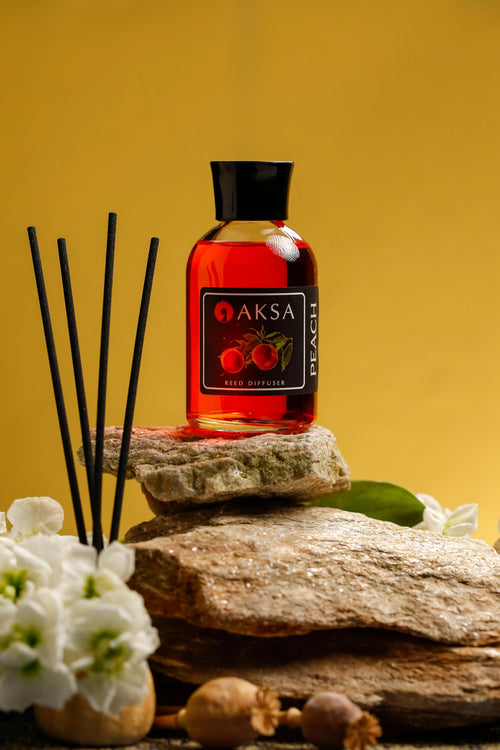 Aksa Peach fragrance bottle and diffuser reeds
