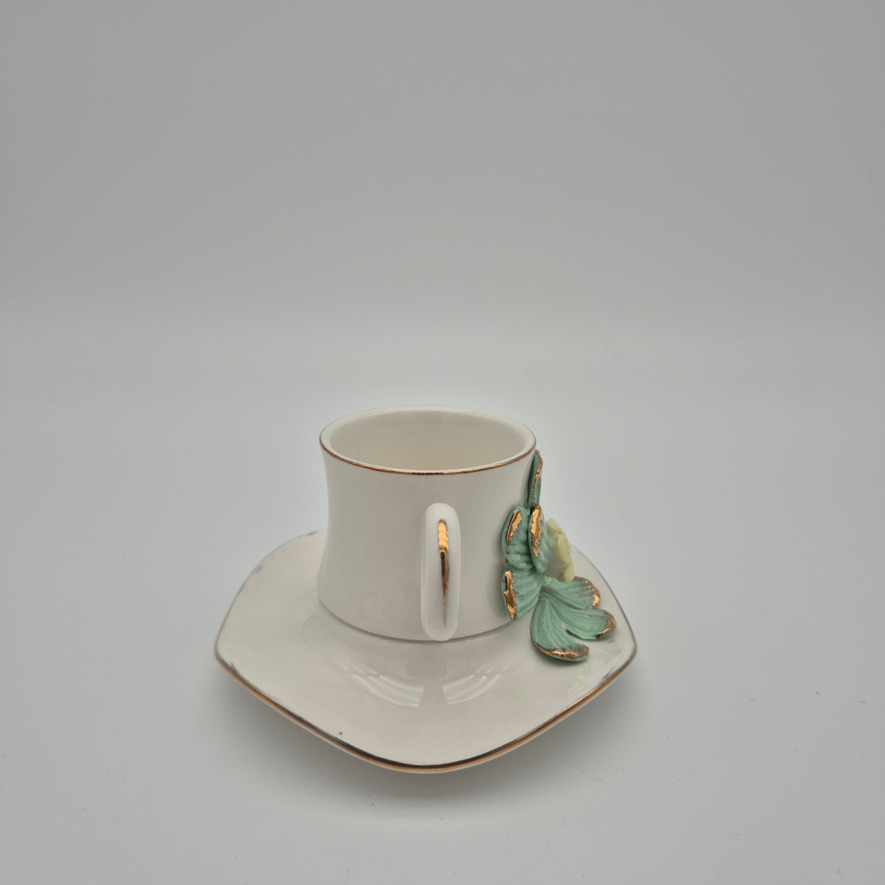 Side view of the green daisy cup and saucer