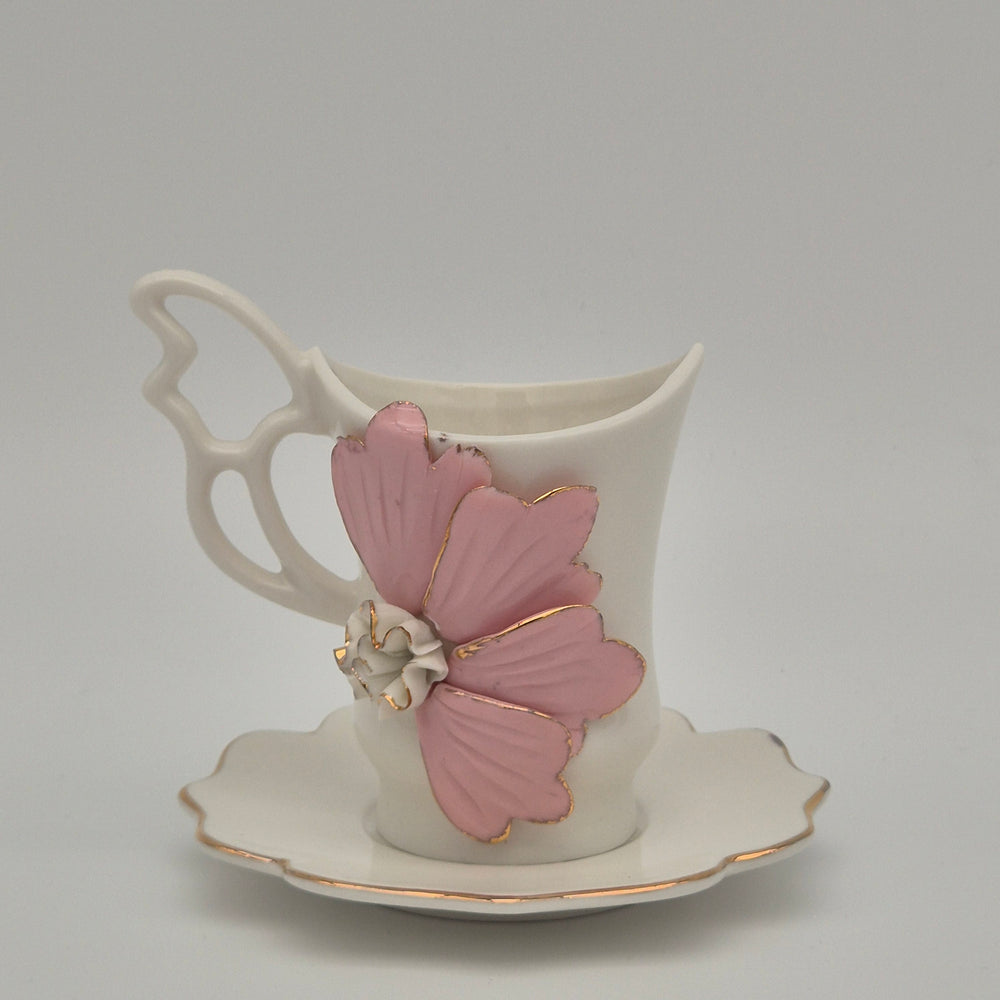 Flowery coffee cup with raised pink flower and matching saucer