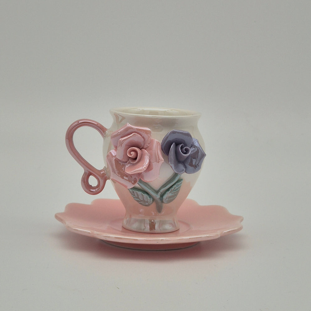 Rosey coffee cup with pink handle and pink saucer