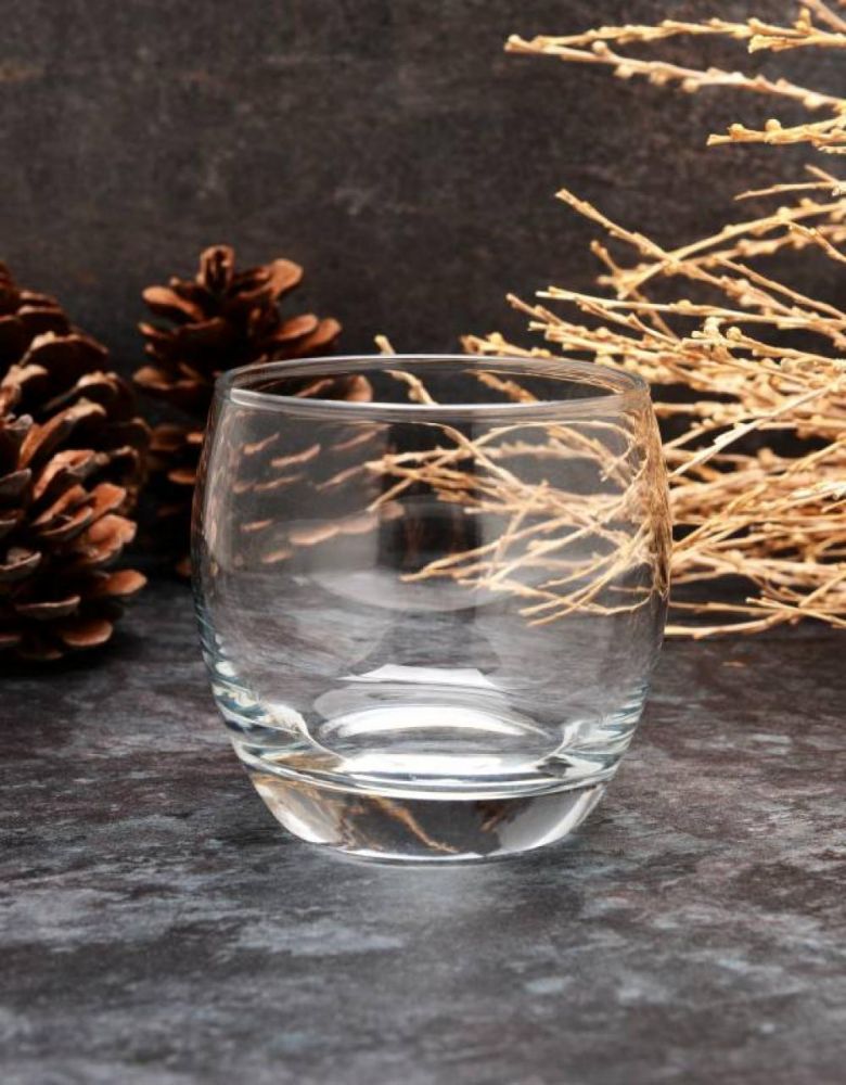 Paşabahçe Empty rounded tumbler on a dark table