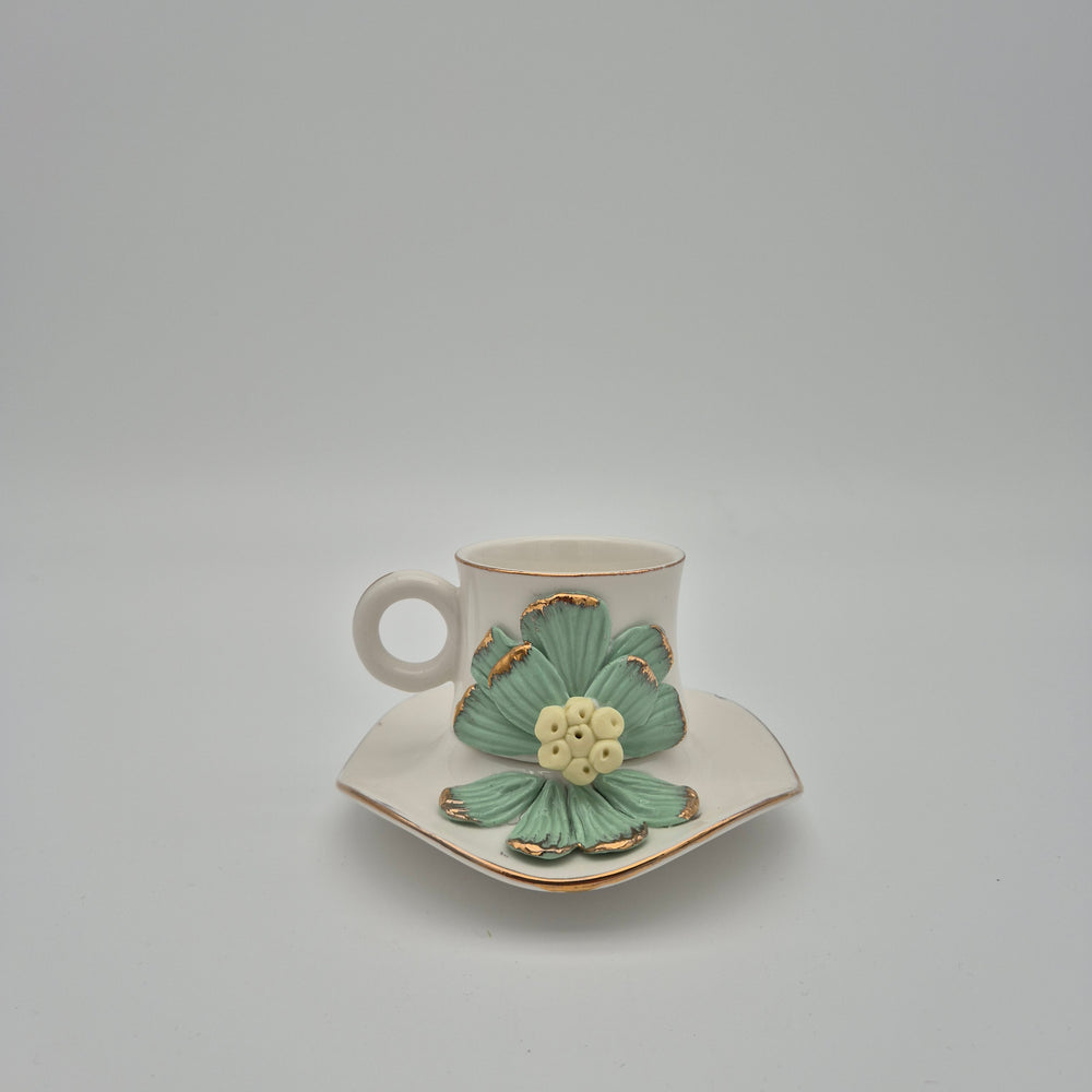 Green daisy coffee cup and matching saucer