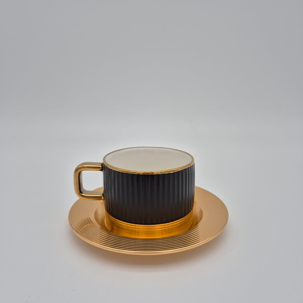 Black Eylul ribbed coffee cup with gold-coloured saucer