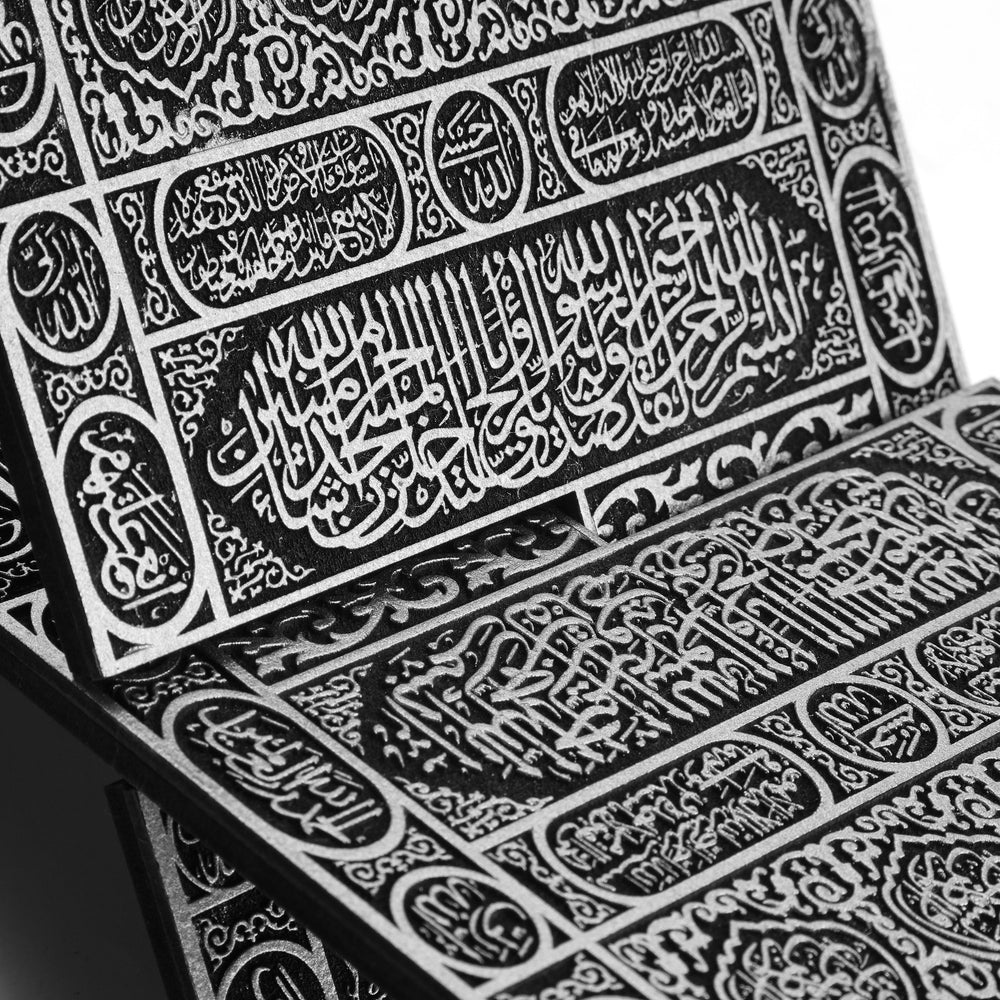 Close-up of the silver-coloured Quran stand calligraphy