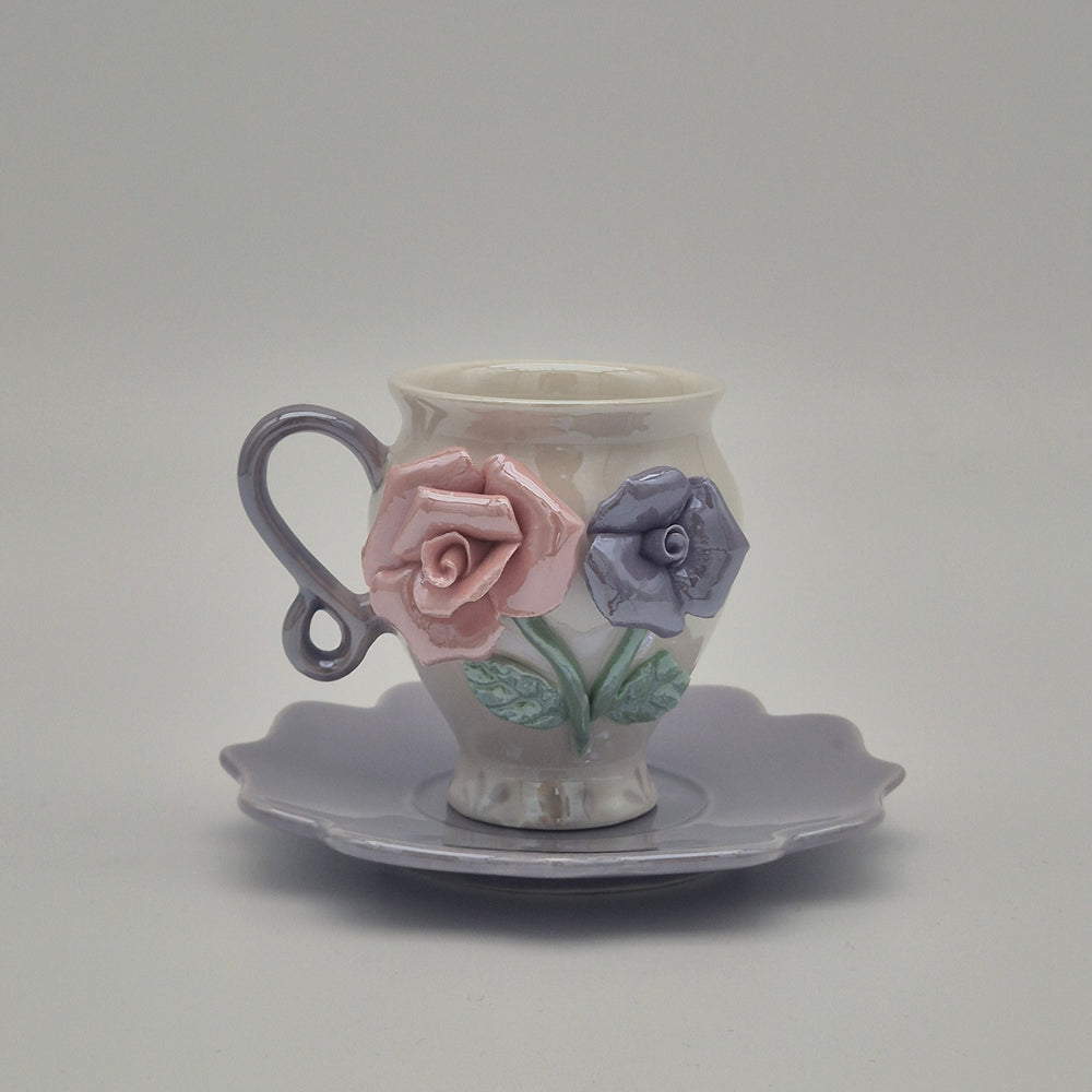 Rosey coffee cup with lavender handle and lavender saucer